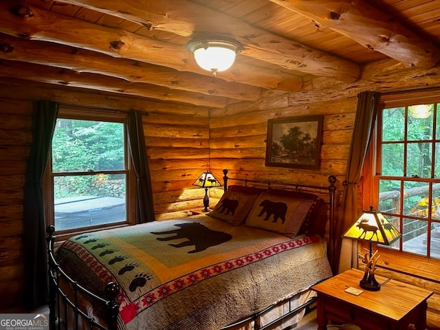 bedroom featuring log walls and wood ceiling