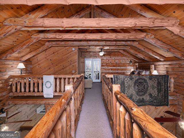 interior space featuring lofted ceiling with beams, wooden ceiling, and rustic walls