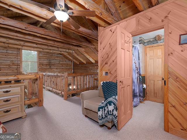 bedroom with vaulted ceiling with beams, wood ceiling, light colored carpet, and wooden walls