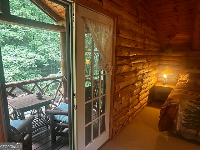 doorway featuring wood ceiling, lofted ceiling, plenty of natural light, and carpet floors