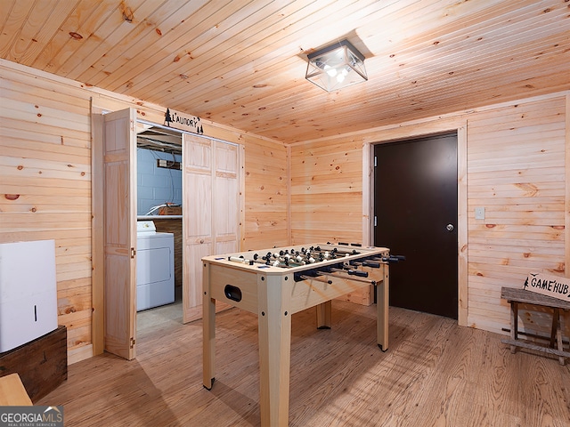 game room with wooden walls, wood ceiling, light hardwood / wood-style floors, and washer / clothes dryer