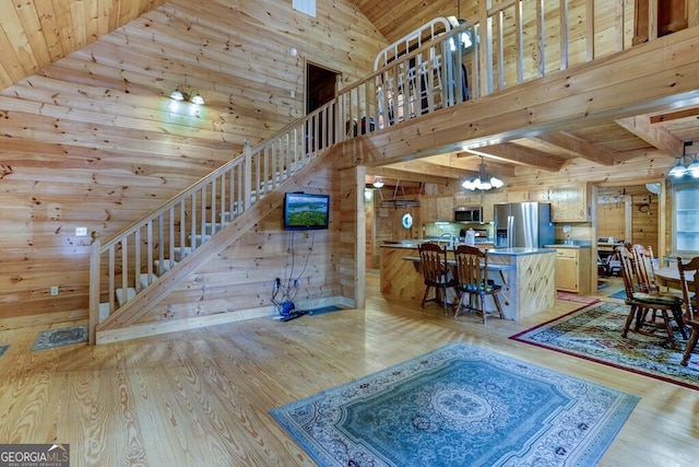 living room featuring light hardwood / wood-style floors, wooden ceiling, and wood walls