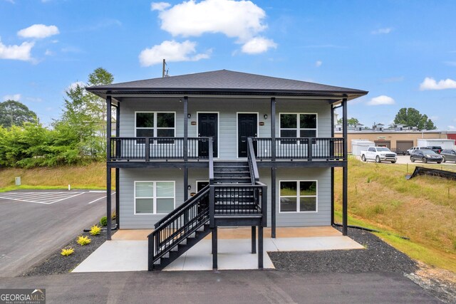 339 Gainesville, Carnesville, GA 30521 - townhome / multi-family property featuring stairway, uncovered parking, and a patio