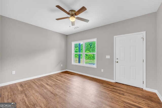 empty room featuring hardwood / wood-style flooring and ceiling fan