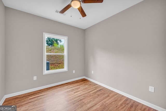 spare room featuring light hardwood / wood-style floors and ceiling fan