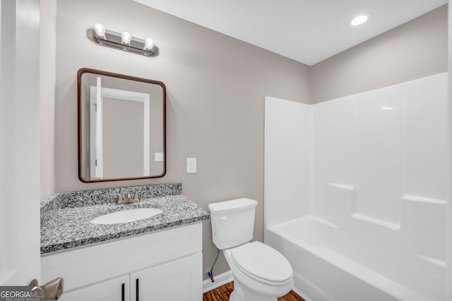 339 Gainesville, Carnesville, GA 30521 - bathroom featuring toilet, vanity, wood finished floors, bathtub / shower combination, and baseboards