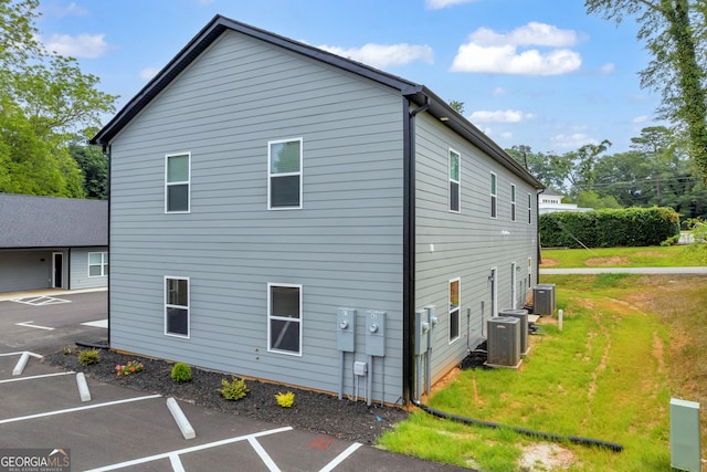 view of side of property with central air condition unit