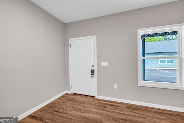 unfurnished room featuring hardwood / wood-style flooring