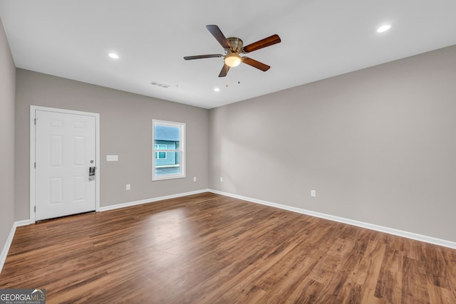 unfurnished room with hardwood / wood-style flooring and ceiling fan