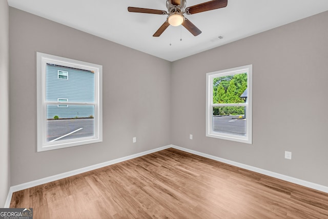 unfurnished room featuring light hardwood / wood-style floors and ceiling fan