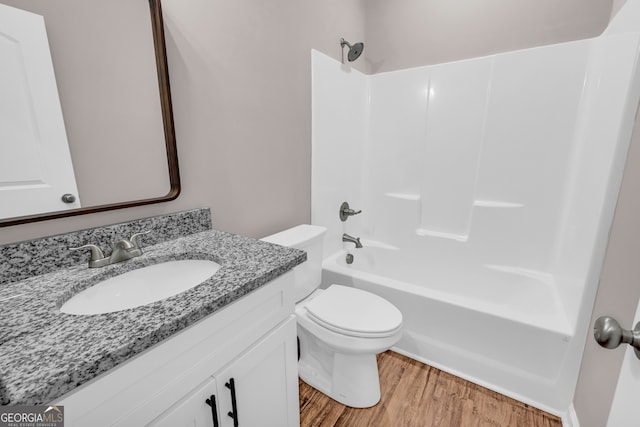 full bathroom featuring vanity, shower / washtub combination, wood-type flooring, and toilet