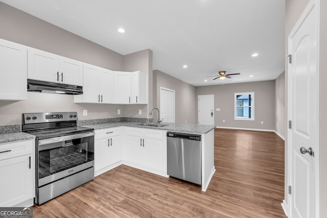 339 Gainesville, Carnesville, GA 30521 - kitchen with stainless steel appliances, under cabinet range hood, a sink, ceiling fan, and white cabinets