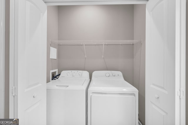 clothes washing area featuring washer and clothes dryer