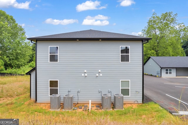 rear view of house with central air condition unit