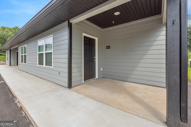 doorway to property with a patio area