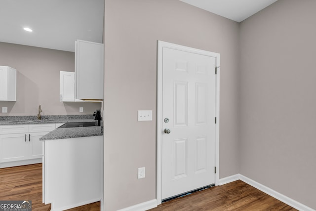 339 Gainesville, Carnesville, GA 30521 - kitchen with stove, white cabinets, wood finished floors, recessed lighting, and light stone countertops