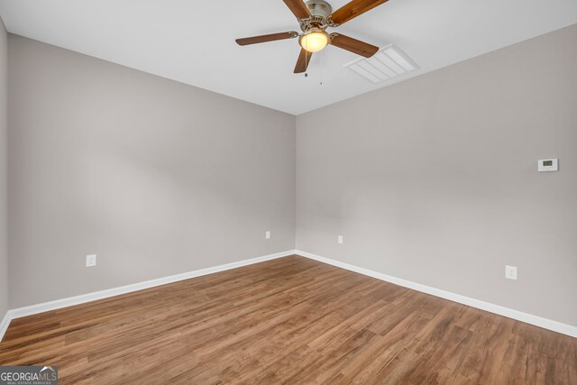 unfurnished room with ceiling fan and hardwood / wood-style floors