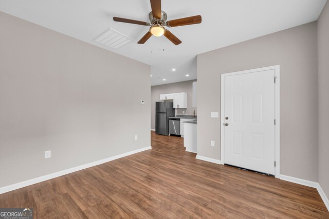 interior space featuring wood-type flooring and ceiling fan