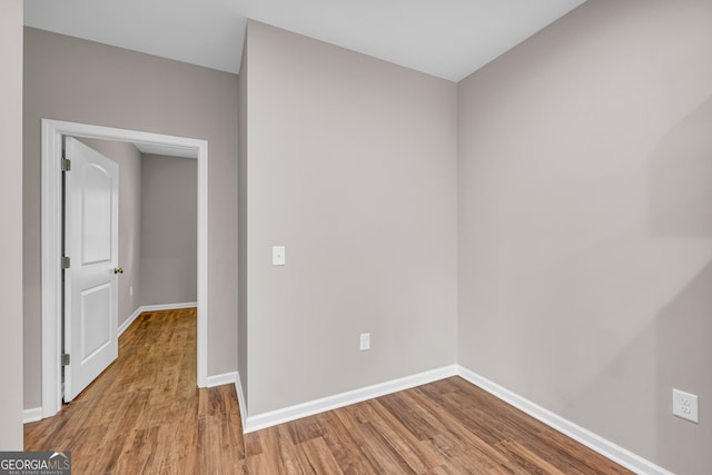 unfurnished room with wood-type flooring