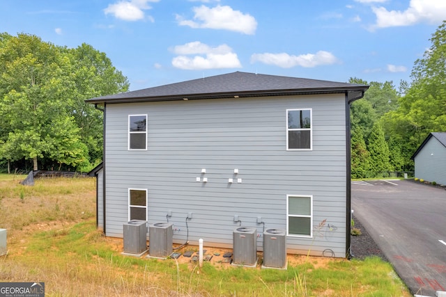 rear view of house featuring cooling unit