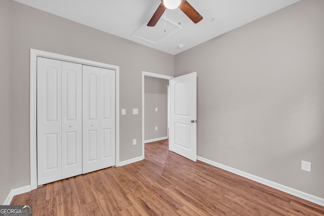 unfurnished bedroom featuring hardwood / wood-style flooring, a closet, and ceiling fan