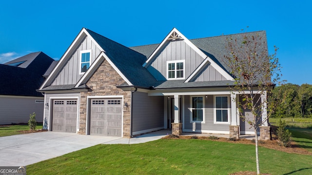 craftsman-style house with a front lawn, covered porch, and a garage