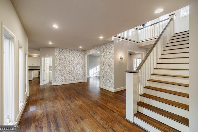 unfurnished living room with dark hardwood / wood-style flooring