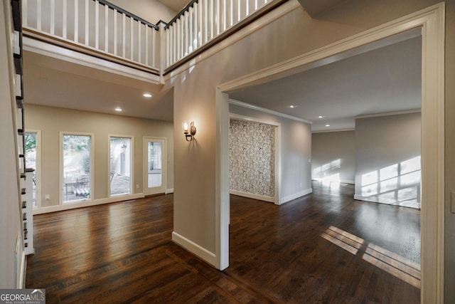 foyer entrance featuring dark hardwood / wood-style flooring and crown molding