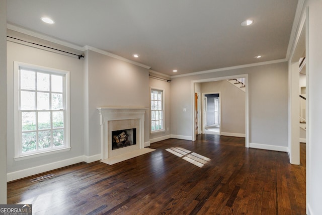 unfurnished living room featuring a high end fireplace, crown molding, and dark wood-type flooring