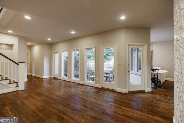 unfurnished living room featuring dark hardwood / wood-style floors