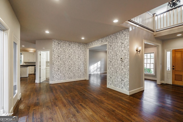 unfurnished living room featuring dark hardwood / wood-style flooring