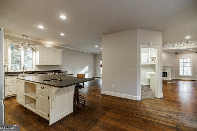 kitchen featuring sink, white cabinetry, and a kitchen island