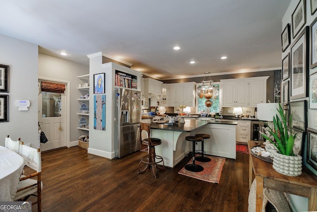 kitchen with white cabinets, a breakfast bar, dark hardwood / wood-style flooring, and stainless steel refrigerator with ice dispenser