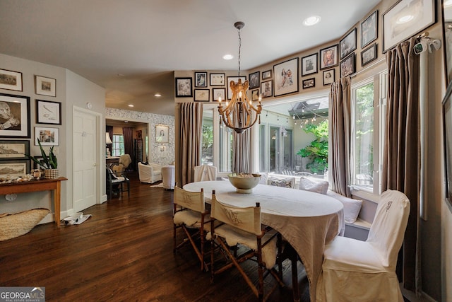 dining area featuring a notable chandelier, dark hardwood / wood-style flooring, and plenty of natural light