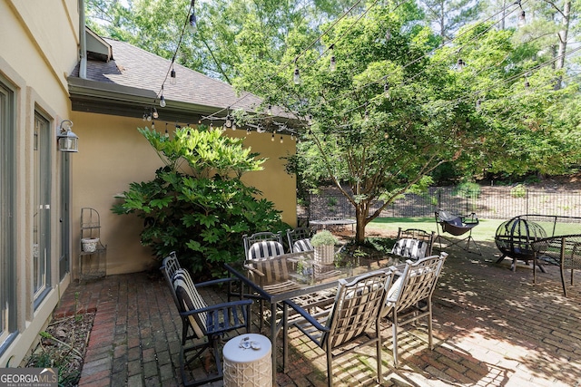 view of patio / terrace with an outdoor fire pit