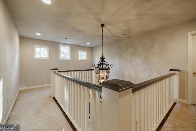 hallway with light colored carpet