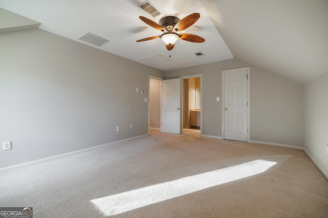 unfurnished bedroom with vaulted ceiling, ceiling fan, and light carpet