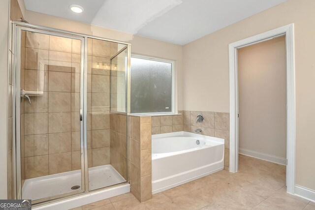 bathroom featuring separate shower and tub and tile patterned floors