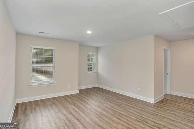 empty room with plenty of natural light and light wood-type flooring