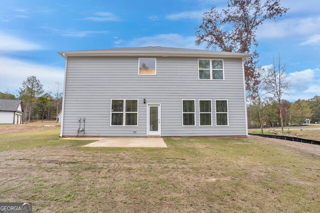 rear view of property featuring a patio area and a lawn