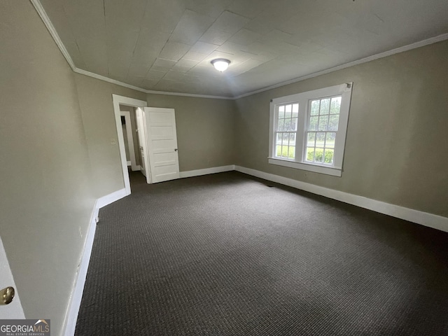 carpeted spare room featuring crown molding