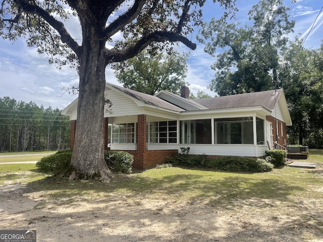 view of side of home with a sunroom