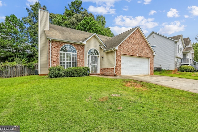 view of property with a garage, central air condition unit, and a front yard