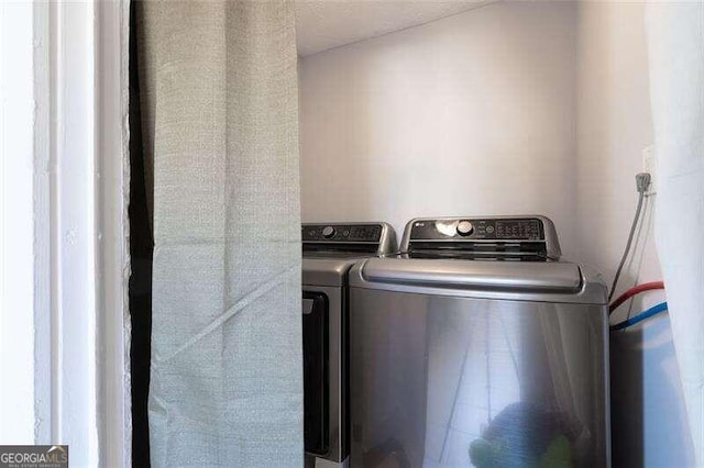 clothes washing area featuring laundry area and washer and dryer