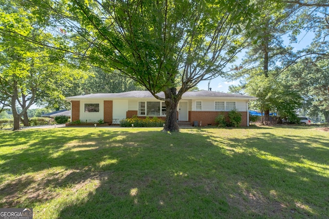 single story home with brick siding and a front yard