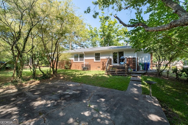 view of front facade with crawl space, a front lawn, and brick siding