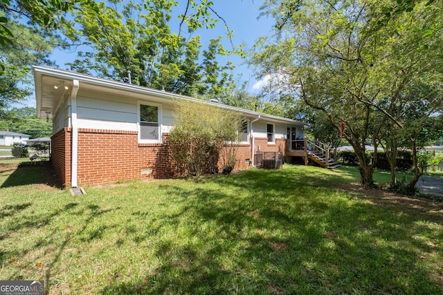 view of home's exterior featuring crawl space, a yard, and brick siding