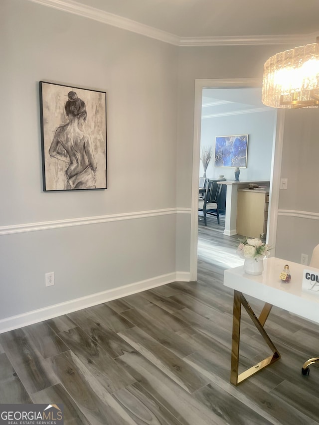 hallway featuring baseboards, an inviting chandelier, wood finished floors, and crown molding