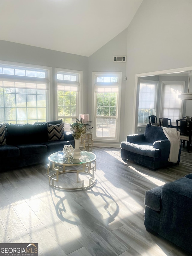 living area with high vaulted ceiling and visible vents