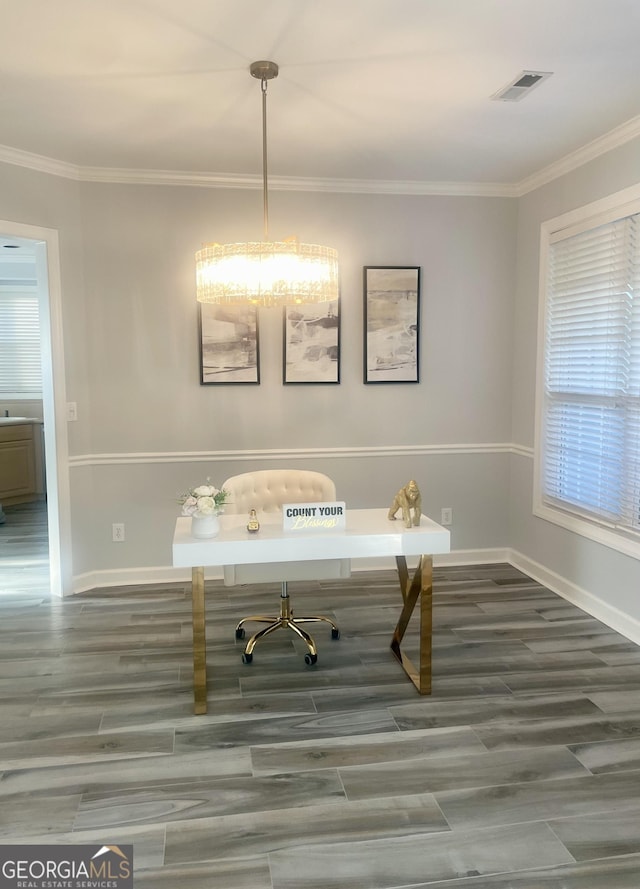 unfurnished office featuring visible vents, crown molding, and wood finished floors